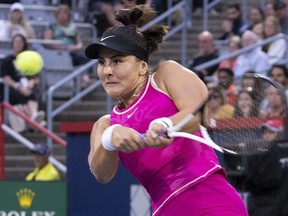 Canadian tennis player Bianca Andreescu hits a return to Camila Giorgi of Italy, during the National Bank Open tennis tournament in Montreal, Tuesday, Aug. 8, 2023.