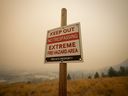 British Columbia's desperate battle against hundreds of wildfires continues on multiple fronts Sunday. A warning sign about fire risk is seen as smoke from wildfires fills the air, in Kelowna, B.C., Saturday, Aug. 19, 2023.