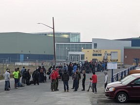 People without vehicles line up to register for a flight to Calgary in Yellowknife on Thursday, August 17, 2023.