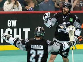 Calgary Roughnecks Kyle Waters celebrates a goal against Colorado Mammoth with teammate Josh Currier during the third game of conference finals at Scotiabank Saddledome