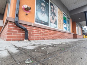 Glass debris are seen on the ground where the windows and glass doors of a business at Castleridge Plaza were shattered and broken during a clash between two Eritrean groups with conflicting views of their home country's politics. Photos were captured on Monday, Sept. 4.