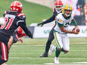 Edmonton Elks quarterback Tre Ford runs with the ball against Calgary Stampeders during the first half of the Labour Day Classic at McMahon Stadium on Monday