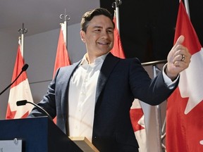 Conservative Leader Pierre Poilievre gives the thumbs up to his caucus as he meets them prior to the Conservative convention, in Quebec City on Sept. 7. Poilievre's comments on the P.A. system of his WestJet flight leaving Quebec City Sunday has drawn criticism.