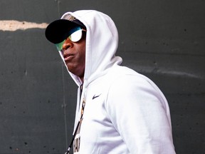 Head coach Deion Sanders of the Colorado Buffaloes walks out of the tunnel before their game against the Oregon Ducks.