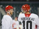 Elias Lindholm and Jonathan Huberdeau chat during Calgary Flames training camp.