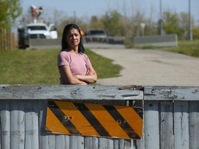 Elaine Savage poses near a proposed LRT line near her Riverstone Road S.E. home in Calgary on Friday, Sept. 22. She and her family have lived at their home for 24 years and she and other residents in the area aren't happy with the proposed plan.
