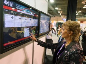 Calgary Mayor Jyoti Gondek tests out a touch screen at the World Petroleum Congress exhibition floor during a tour on Sunday, September 17, 2023.
