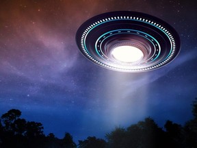 This photo illustration shows an unidentified flying object with a light source beaming down.