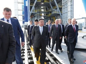 This picture taken on September 13, 2023 and released by North Korea's official Korean Central News Agency (KCNA) on September 14 shows North Korea's leader Kim Jong Un (C) and Russia's President Vladimir Putin (R) visitng the Vostochny Cosmodrome in Russia's Amur region.