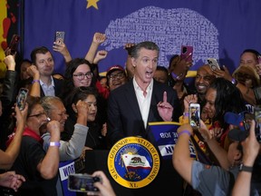 California Gov. Gavin Newsom signs the fast food bill surrounded by fast food workers at the SEIU Local 721 on Thursday, Sept. 28, 2023, in Los Angeles, Calif.
