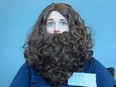 Woman in Jesus Christ wig (and beard) after employer said her dyed pink hair is not allowed.