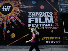 A woman walks along the closed-off streets at the Toronto International Film Festival, in Toronto, Thursday, Sept. 7, 2023. Hollywood A-listers Mark Ruffalo and Rachel McAdams are among 200 plus film industry workers around the world who signed an open letter imploring the Toronto International Film Festival to end ties with sponsor, the Royal Bank of Canada.