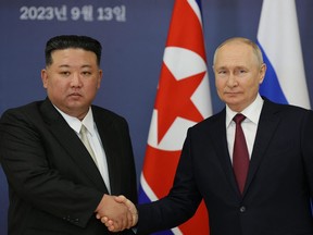 This pool image distributed by Sputnik agency shows Russian President Vladimir Putin (right) and North Korea's leader Kim Jong Un shaking hands during their meeting at the Vostochny Cosmodrome in Amur region on Sept. 13, 2023.