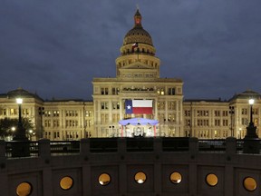 In this Jan. 14, 2019 file photo, a large Texas flag hangs from the Texas State Capitol in Austin, Texas.