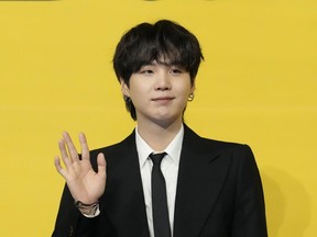 Suga, a member of South Korean K-pop band BTS, poses for photographers ahead of a press conference to introduce their new single "Butter" in Seoul, South Korea on May 21, 2021.