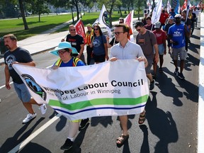A Labour Day march organized by the Winnipeg Labour Council walks down Broadway on the way to the Canadian Museum for Human Rights in Winnipeg on Monday, Sept. 4, 2023.