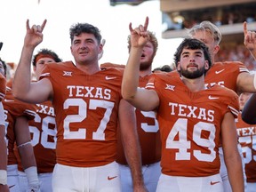 The Texas Longhorns stand for the playing of The Eyes of Texas after the game against the Kansas Jayhawks.