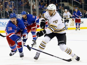 A.J. Greer of the Boston Bruins scores an empty-net goal against the New York Rangers.