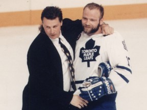 Former Los Angeles Kings coach Barry Melrose hugs his cousin, Leafs great Wendel Clark.
