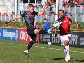 Forge Rezart Rama (L) goes up for a ball in front of Cavalry Sergio Camargo during CPL soccer action between Cavalry FC and Forge FC on ATCO Field at Spruce Meadows on Saturday