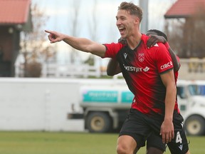 Cavalry Daan Klomp (4) celebrates his first half goal with William Akio during CPL playoff soccer action between Cavalry FC and Pacific FC on ATCO Field at Spruce Meadows in Calgary Saturday, October 21,