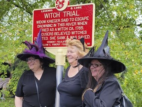 In this Sept. 16, 2023 photo, provided by Alexina Jones, people dressed as witches gather near a newly installed marker, in Pownal, Vt., that recognizes the survivor of Vermont's only recorded witch trial.