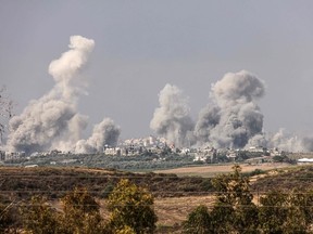 A picture taken from the southern Israeli city of Sderot on October 23, 2023, shows smoke and debris ascending over the northern Gaza Strip following an Israeli strike, amid the ongoing battles between Israel and the Palestinian group Hamas. Thousands of people, both Israeli and Palestinians have died since October 7, 2023, after Palestinian Hamas militants based in the Gaza Strip, entered southern Israel in a surprise attack leading Israel to declare war on Hamas in Gaza on October 8. (Photo by Jack Guez / AFP)