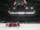 Calgary Flames huddle for a conference during training camp at the Saddledome.