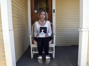 Abby Swoveland sits with what the Return to Nature Funeral Home said were her mother's ashes in Colorado Springs, Colo., on Thursday, Oct. 19, 2023.
