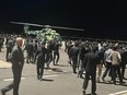 People in the crowd shout antisemitic slogans at an airfield of the airport in Makhachkala, Russia, Monday, Oct. 30, 2023.