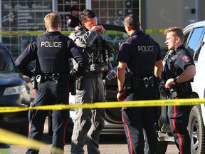 Calgary police at the scene of a shooting at the Falconridge Plaza yesterday.