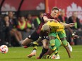 Canada's Christine Sinclair, 12, and Jamaica's Deneisha Blackwood, 14, battle for the ball during second half CONCACAF women's championship soccer series match in Toronto on Tuesday Sept. 26, 2023. Canada captain Sinclair will wrap up her international career in her backyard, with December games against Australia in Langford, B.C. and Vancouver.