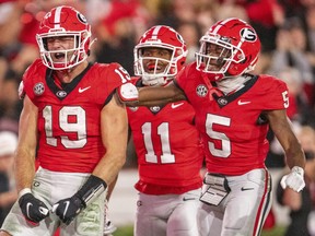 Georgia tight end Brock Bowers (left) reacts after a touchdown against Kentucky.