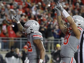 Ohio State running back TreVeyon Henderson, left, and tight end Gee Scott celebrate Henderson's touchdown against Michigan State.