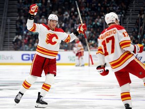 Nikita Zadorov #16 celebrates a goal by Yegor Sharangovich #17 of the Calgary Flames during the third period against the Seattle Kraken