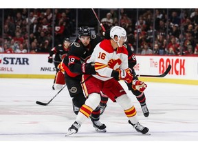 Nikita Zadorov of the Calgary Flames gets called for interference on Drake Batherson of the Ottawa Senators during the second period at Canadian Tire Centre