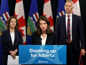 Premier Danielle Smith, with Environment and Protected Areas Minister Rebecca Schulz, left, and Affordability and Utilities Minister Nathan Neudorf, take part in a news conference on Monday, Nov. 27, 2023, where they outlined the Alberta Sovereignty Within A United Canada Act motion that will be brought before the Alberta legislature.