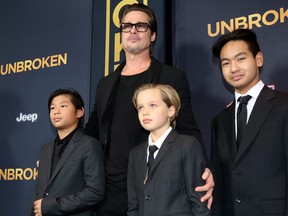 From left, Pax Jolie-Pitt, Brad Pitt, Shiloh Jolie-Pitt and Maddox Jolie-Pitt arrive at the Los Angeles premiere of "Unbroken" at TCL Chinese Theatre on Dec. 15, 2014.