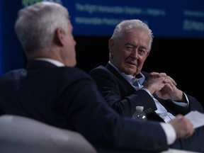 Former prime minister Stephen Harper, left, and Preston Manning speak at a conference in Ottawa in March. A COVID-19 panel led by Manning released its report on Wednesday.