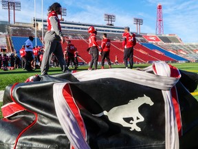The Calgary Stampeders warm up before a team practice in Calgary on Tuesday