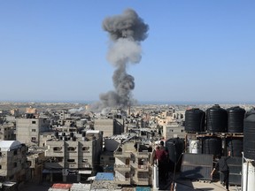 Smoke billows after an Israeli strike on Rafah, in the southern Gaza Strip on November 23, 2023,.