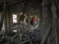 Palestinians look at the apartment of Khaled Kharousha that was destroyed by the Israeli military in Nablus, West Bank, Friday, Nov. 3, 2023.