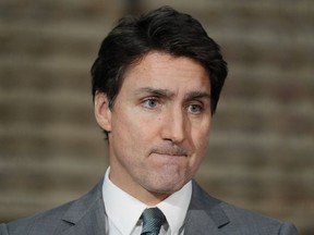 Prime Minister Justin Trudeau pauses while speaking about the Israel-Hamas war during a news conference at lithium battery manufacturer E-One Moli Energy (Canada), in Maple Ridge, B.C., on Tuesday, November 14, 2023.