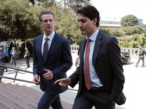 Prime Minister Justin Trudeau, right, arrives with California Gov. Gavin Newsom prior to signing a memorandum of cooperation on climate change at the California Science Center outside the ninth Summit of the Americas, in Los Angeles, on Thursday, June 9, 2022. Prime Minister Justin Trudeau is headed to California for three days of meetings at the Asia-Pacific Economic Cooperation in San Francisco.THE CANADIAN PRESS/AP, Richard Vogel
