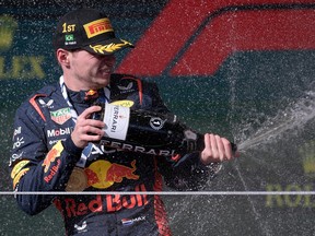 Red Bull's Max Verstappen celebrates on the podium after winning the Formula One Brazil Grand Prix in Sao Paulo, Brazil, on November 5, 2023.