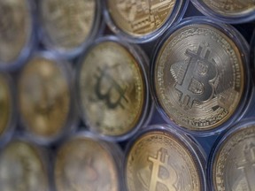 In this file photo taken on October 20, 2021 physical imitations of Bitcoins are pictured at a cryptocurrency exchange branch near the Grand Bazaar in Istanbul. - Bitcoin saw its price plunge in early 2022 in the wake of major tech groups, challenging the idea that cryptocurrency is some sort of inflation-proof digital gold championed by some of its proponents.