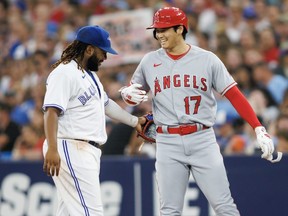 Shohei Ohtani of the Los Angeles Angels is greeted by Vladimir Guerrero Jr. at first base this past season.