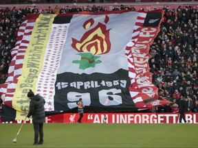 Fans hold up a tribute to the victims of the Hillsborough disaster before the English Premier League soccer match between Liverpool and Brighton in 2019.