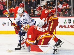 Daniel Vladar #80 of the Calgary Flames stops a shot from Michael Eyssimont #23 of the Tampa Bay Lightning during the second period an NHL game at Scotiabank Saddledome