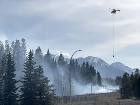 Helicopters drop water on an out of control fire near Banff. The fire began from a prescribed burn near the townsite.